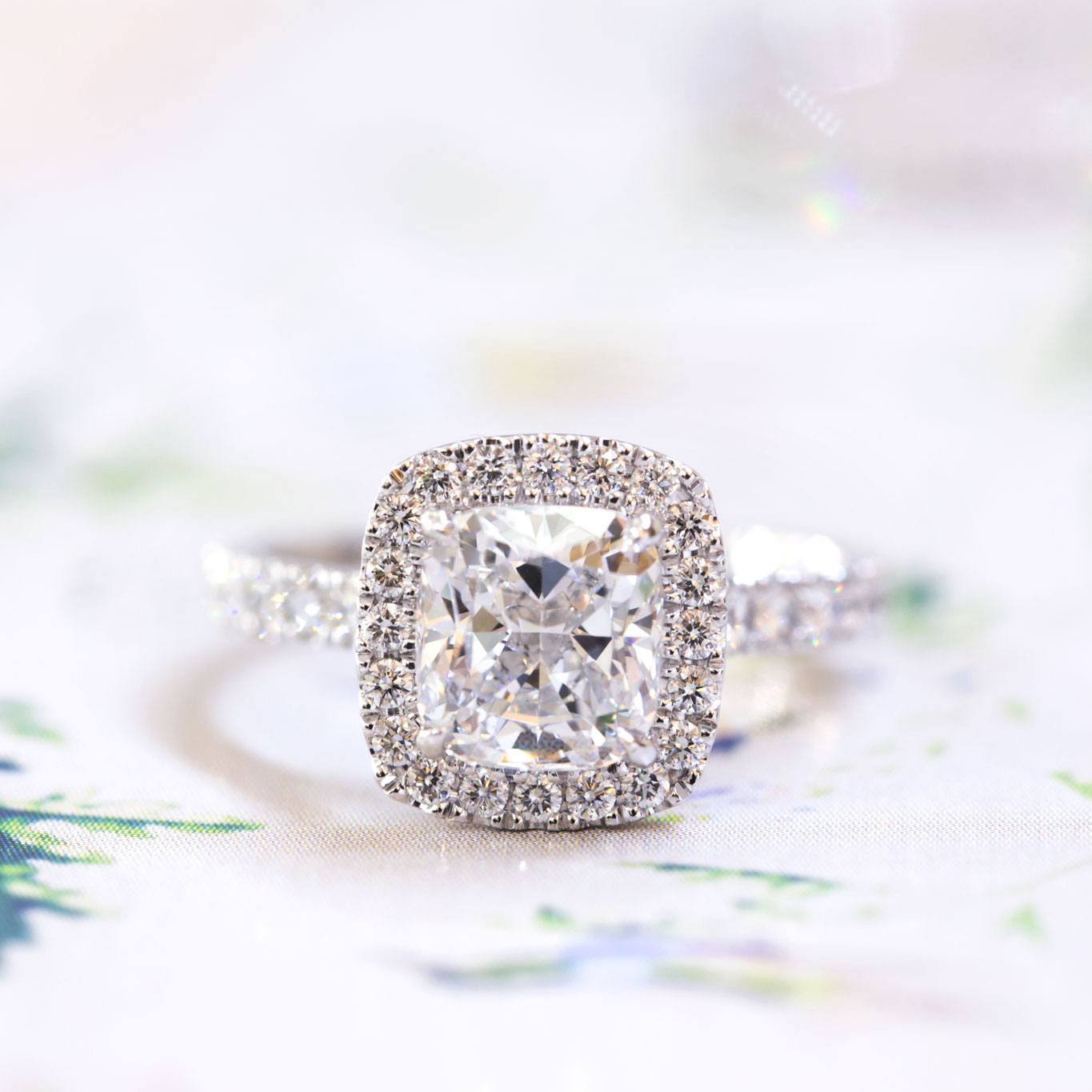 Cushion cut diamond halo engagement ring
